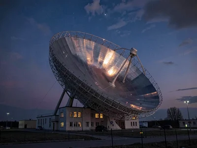Radio telescope dish reflecting twilight colors