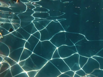 Soft caustic pattern filtered through deep clear water