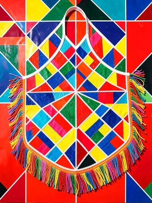 Bride's beaded ceremonial apron flat-lay — layered fringe and geometric panels