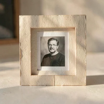 Papercraft ig-tile of a small paper-cut photo print in a paper-cut frame, soft w