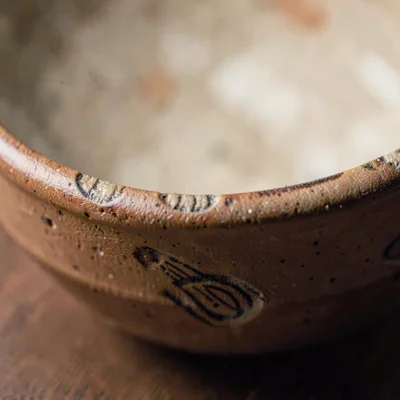 macro of a hand-thrown earthenware bowl rim with finger marks