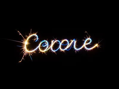 Light trail of a single sparkler writing a word in cursive, dark background