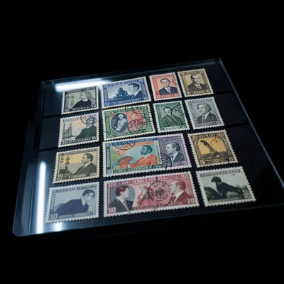 A stack of vintage postage stamps from the 1960s arranged in a grid pattern on t