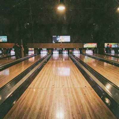 Grainy digital illustration, bowling alley lanes at night , film grain texture o