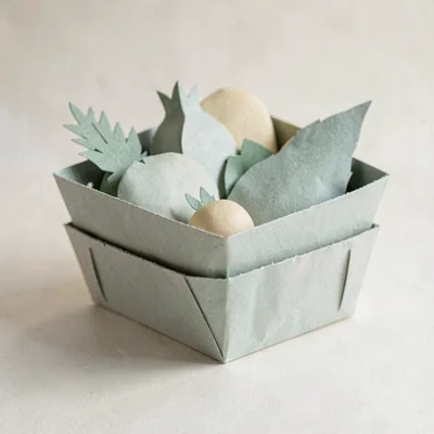 Papercraft onboarding illustration of a layered paper market basket with paper p