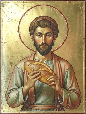 Frontal portrait of a baker holding a loaf of bread aloft with a golden halo