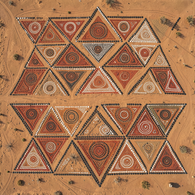 Aboriginal Australian dot painting aesthetic,. An aerial-view geometric composition built from repeating triangles acros