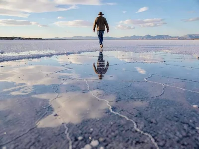 Person walking on sky literally through reflection
