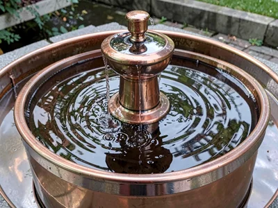 Copper fountain showing water flow
